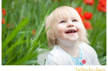 young girl smiling in poppy field